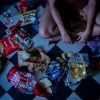 a woman surrounded by junk food