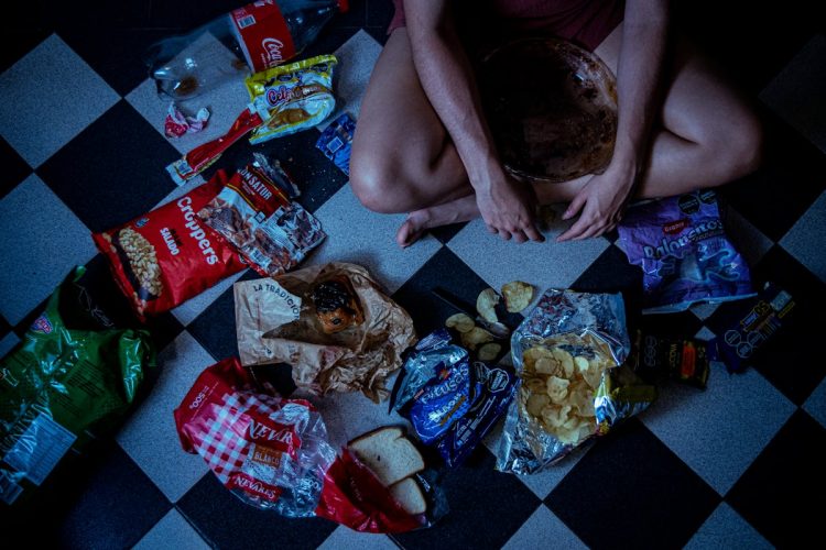 a woman surrounded by junk food